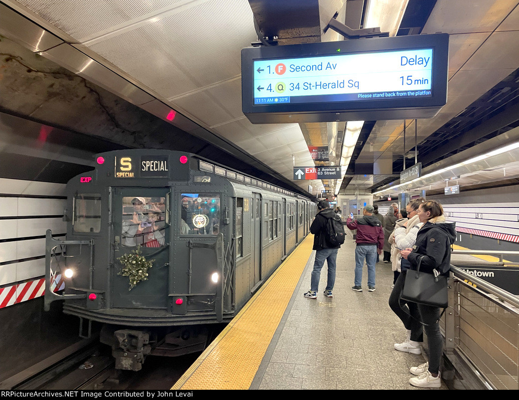 The second holiday train trip of the day is about to depart Lexington Ave-63 Street heading down to 2nd Ave Station